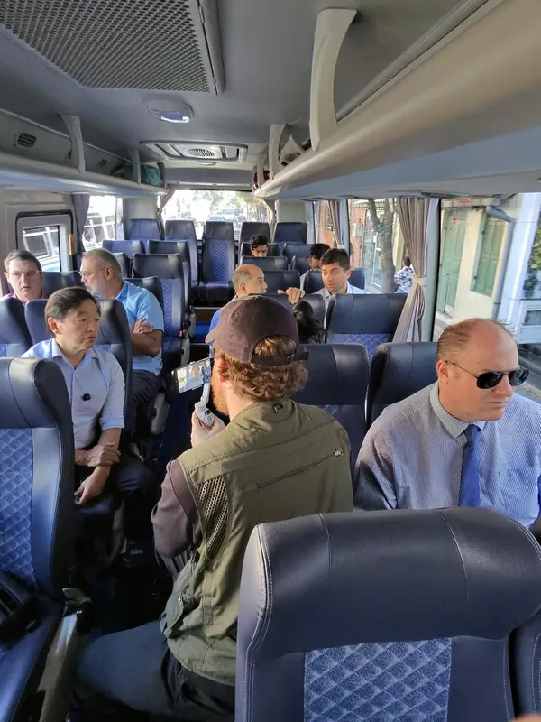 Rhett filming on a phone stabiliser on a bus of surgeons in Sri Lanka.